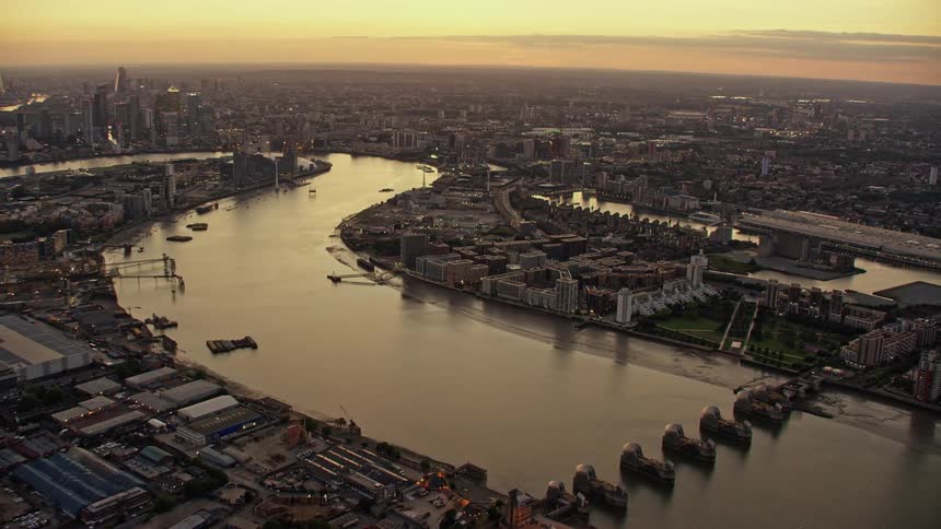 Aerial view of skyline of london and buildings next to the river thames at dusk