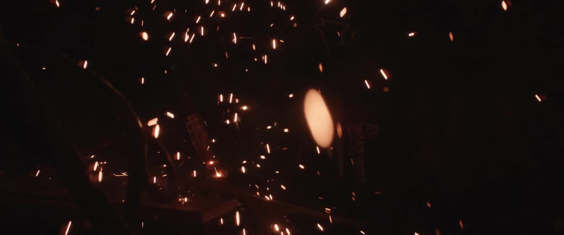 Person uses welding machine producing sparks