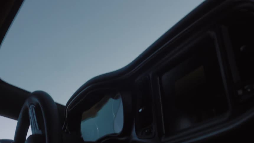 A car being driven wildly as seen from the front seat
