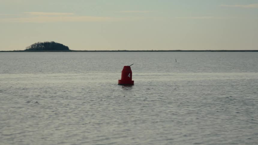 Strong current flows past a channel buoy