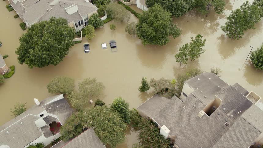 A neighborhood flooded with murky brown water