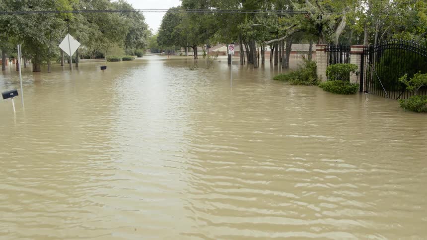 A flooded street hear homes in a small neighborhood