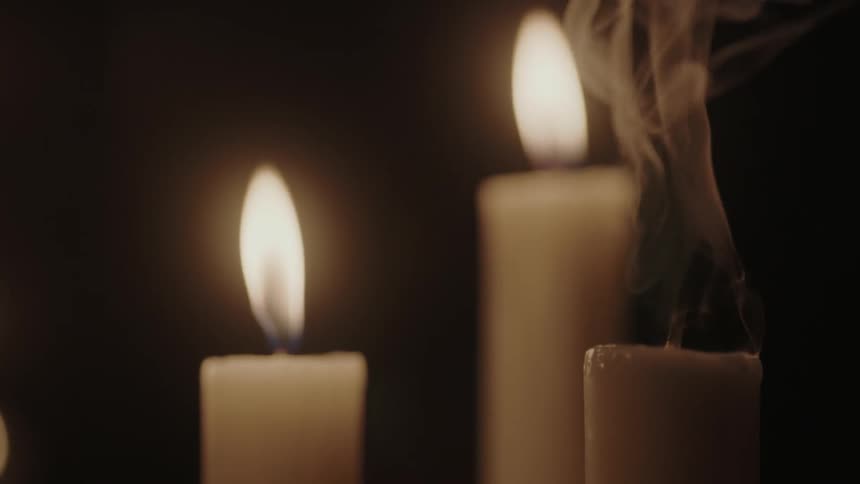 Candles slowly burn and one is put out