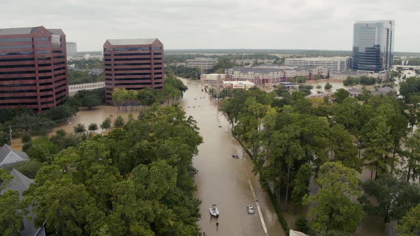 Aerial view of the cars and boats on the flooded streets on a city at daytime