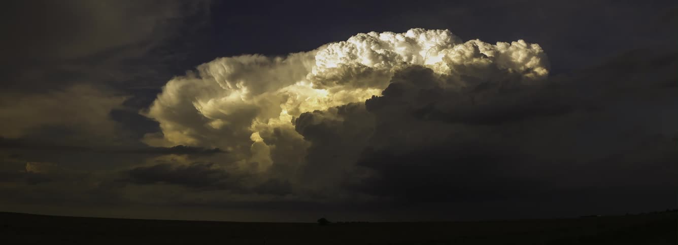 Large rolling clouds over fields and farmland