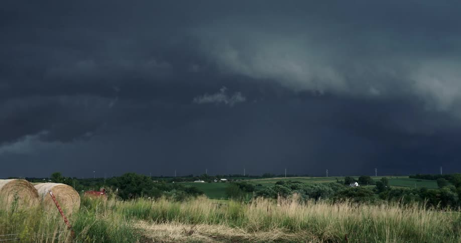 Time lapse of dark storm thunderstorm clouds rolling over the countryside at daytime