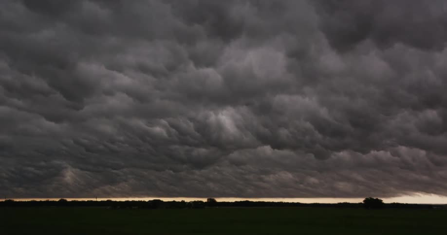 Large grey clouds over farmland