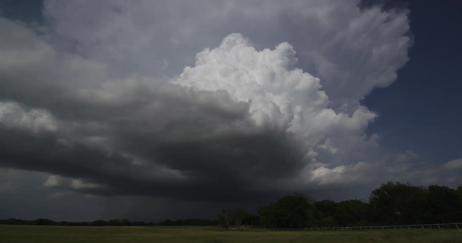 Large white cloud rolling across a field in the country