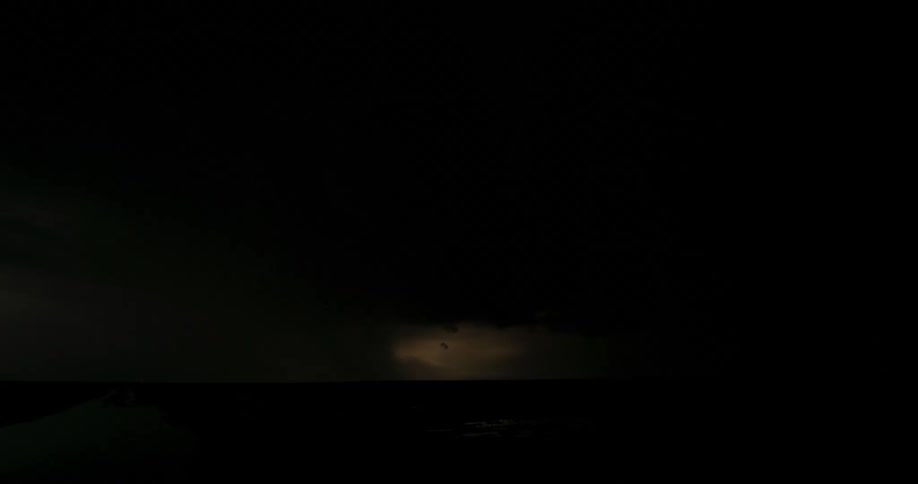 Strikes of lightning light up the dark sky