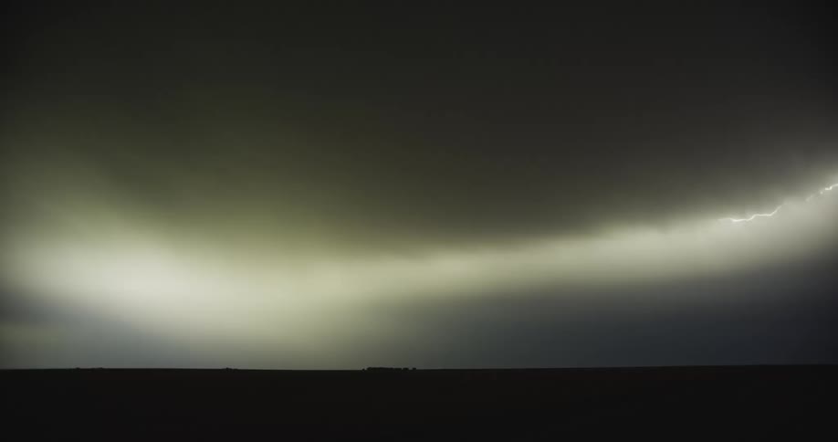 Flashes of lightning light up the dark sky