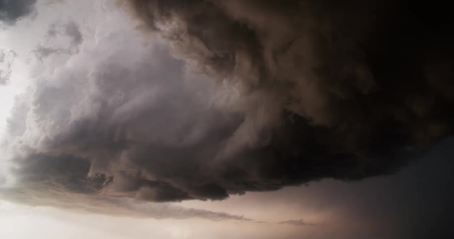 Dark storm clouds rolling through the sky giving way to lighter skies
