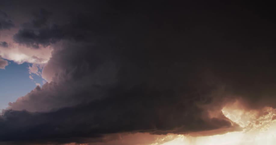 Dark storm clouds float and gather in the sky with lightnings flashing