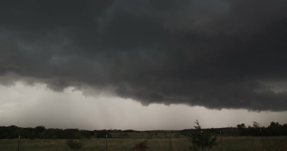 Time lapse of dark storm thunderstorm clouds rolling over the countryside at daytime