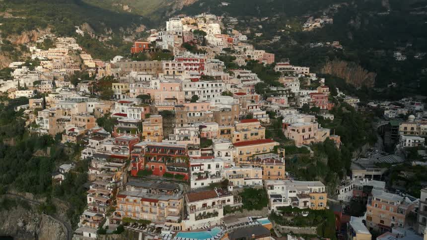 Aerial view of a the packed houses of a village on the mountains at morning