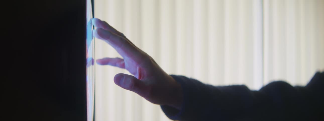 A view of a person touching a screen