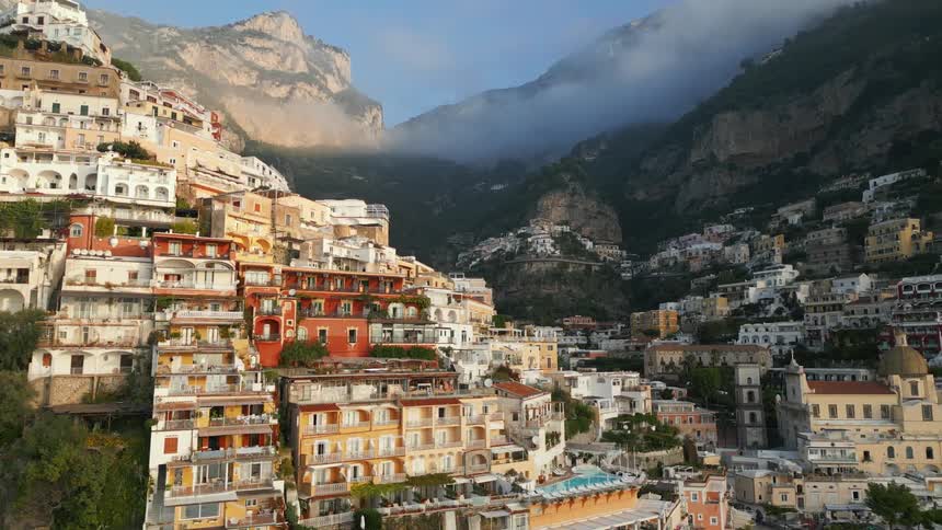 Aerial view of positano with buildings in the hills leading down to the amalfi coast