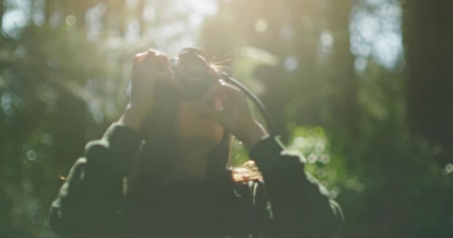 Woman taking pictures with a camera in the wilderness