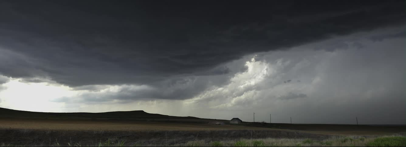 Time lapse of dark storm clouds rolling over the countryside at daytime