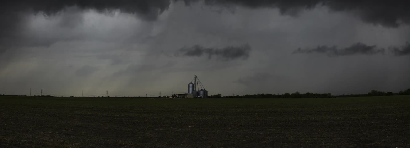 Timelapse of storm clouds developing over farmland during the day