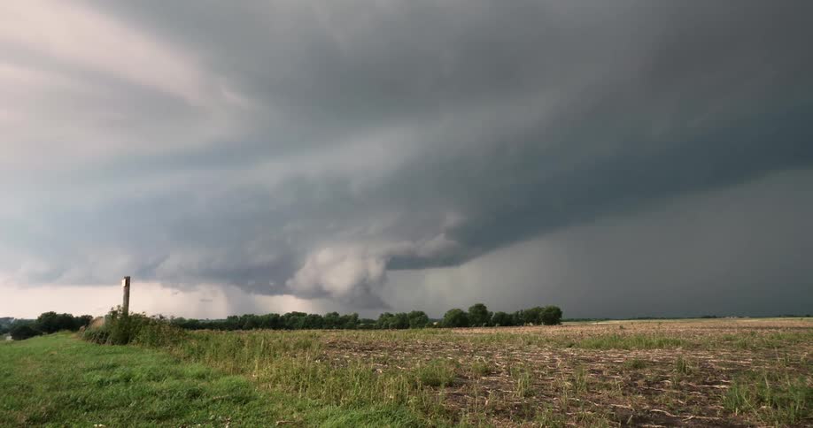 Time lapse of dark storm thunderstorm clouds rolling over the countryside at daytime