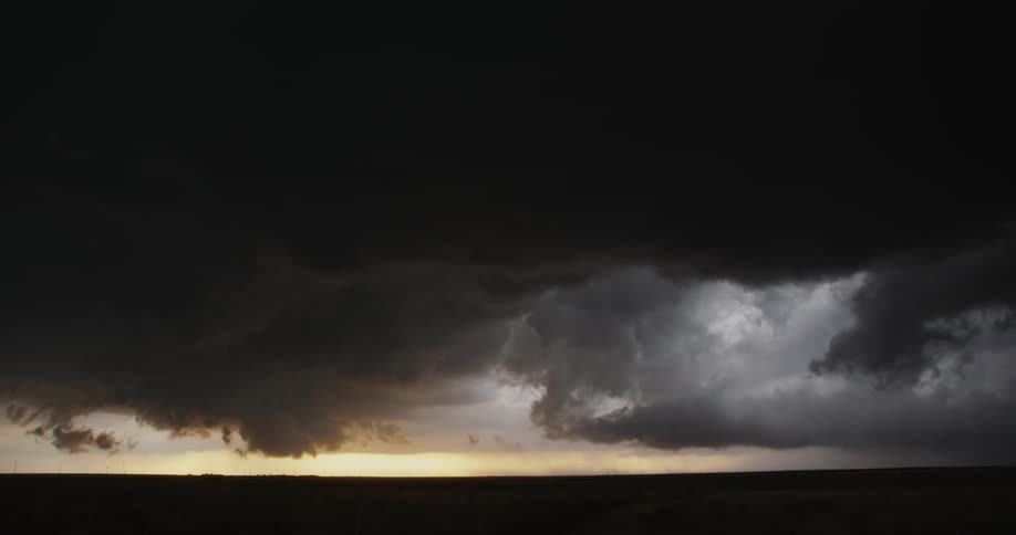 Timelapse of dark storm clouds passing over a rural landscape