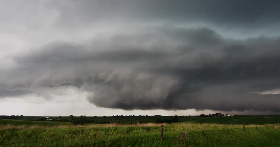 Storm clouds move over rural land as lightning strikes