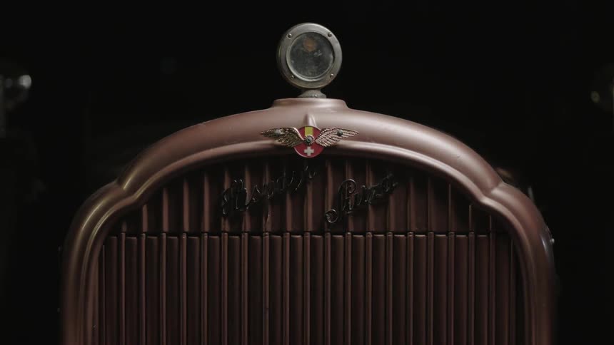 A car is slowly lit in the darkness