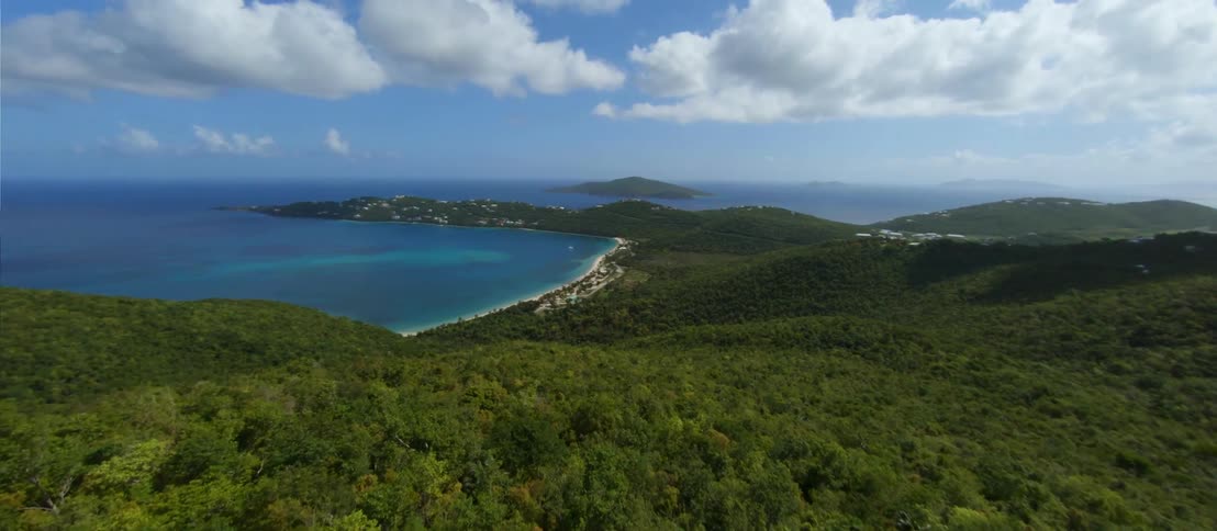 FPV - Aerial view of the jungle on the mountains of an island close to small coastal towns