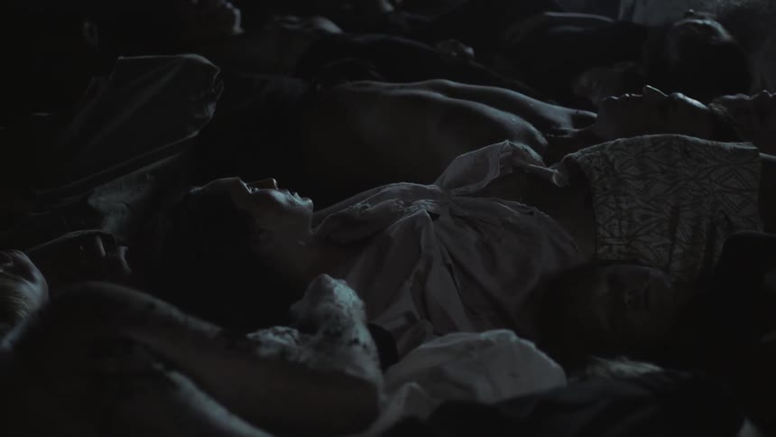 A pile of dead people in a dark room