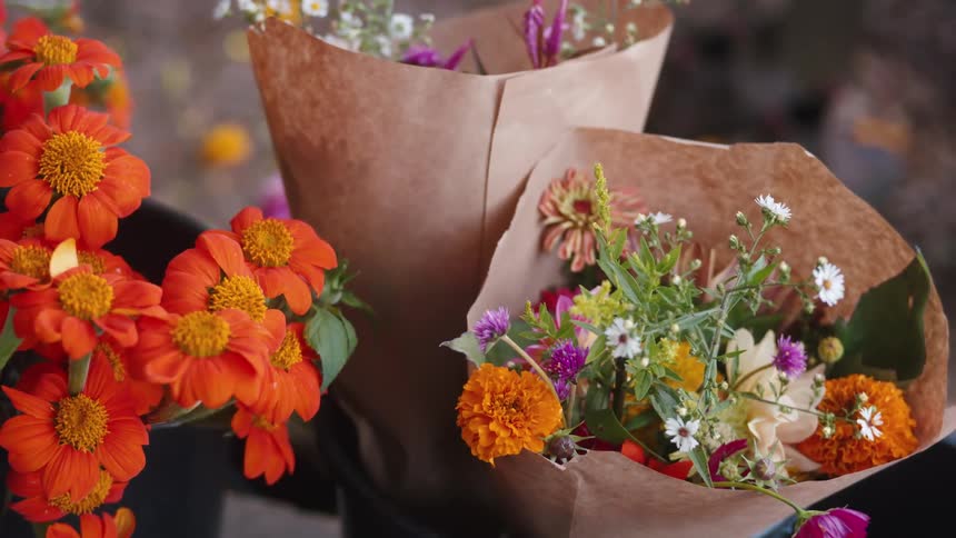 Bouquets of colorful flowers displayed on a rack at a flower shop