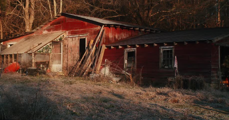 A rustic red barn in the morning sun