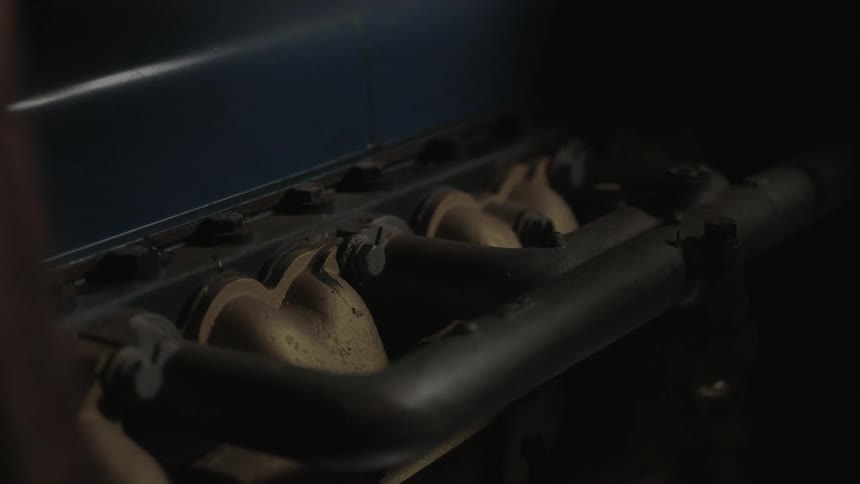 An engine block sits in a dark area
