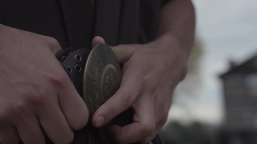 A person buckles their belt