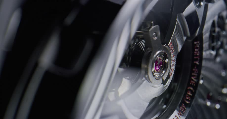 Close up of the gears of a luxury wristwatch clock spinning
