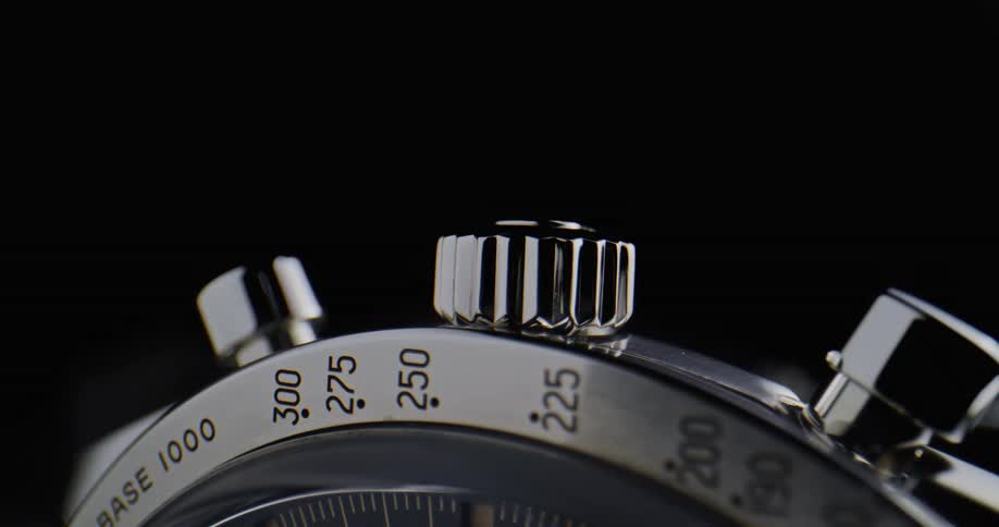 The watch has two buttons and a dial