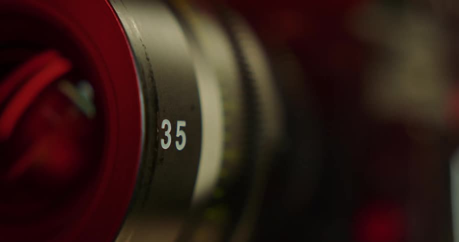 A long camera lens protrudes from a camera