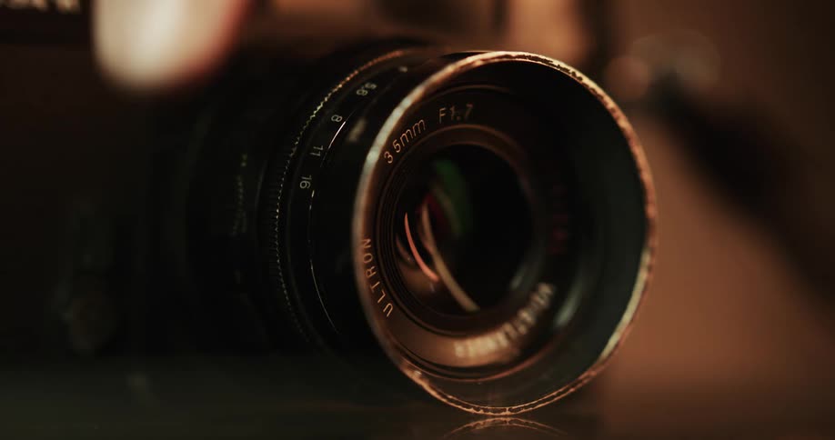 A hand picking up a camera