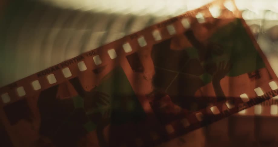 Close up of photo negatives being examined against the light