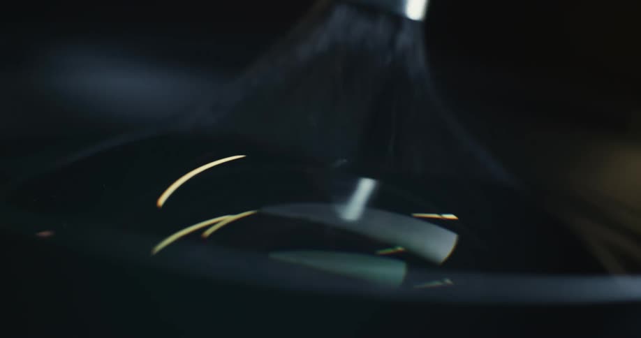 Closeup of camera lenses being cleaned by brush