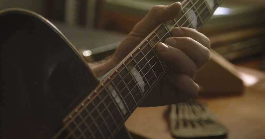 Closeup of hands playing electric guitar