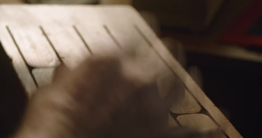 Close up of hands hitting on wooden percussion instrument