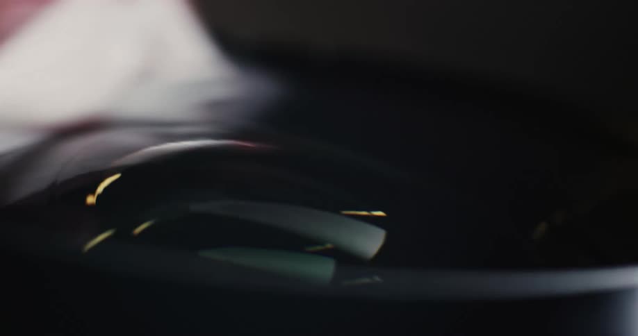 A person is cleaning a surface with a piece of cloth