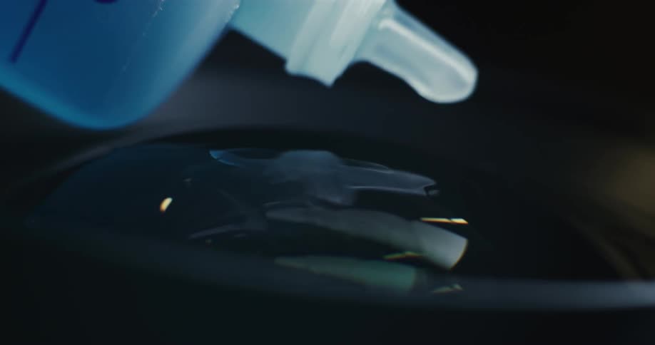 Closeup of lens cleaning solution dripping on camera lenses