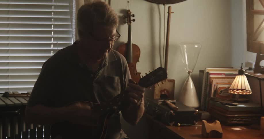 A man playing a small guitar