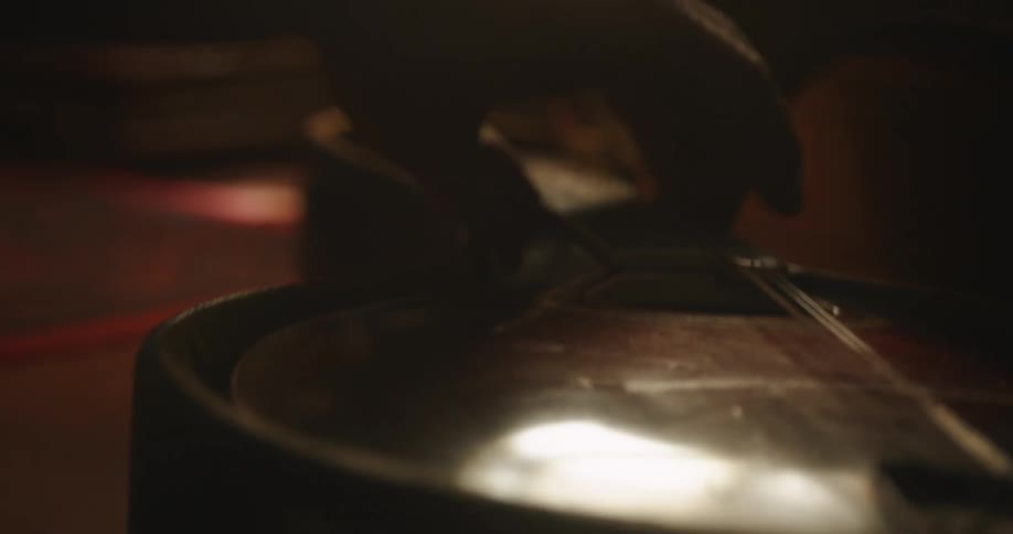 A person removes the violin from the case