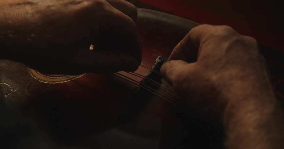 A person is tuning his violin