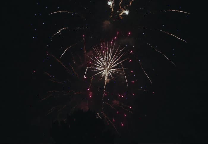 A firework show is on display during the night time