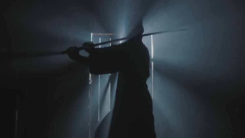 A person is getting ready to swing a sword