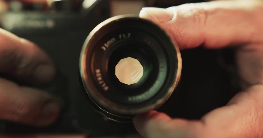 Hands adjusting a lense on a camera