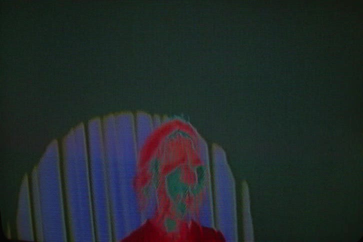 Static interrupts digitized video of woman pulling up her jacket